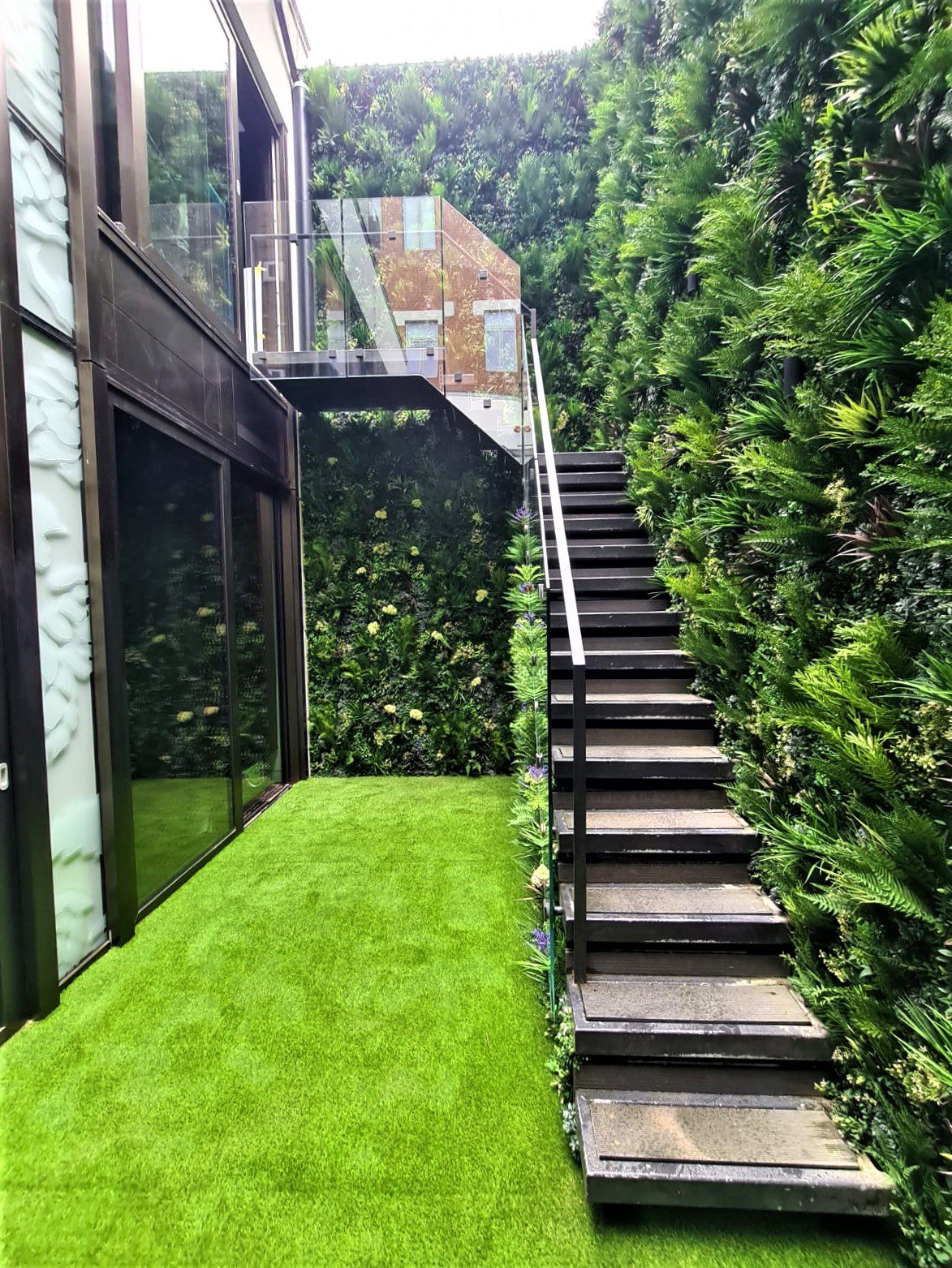 Basement staircase in London, surrounded by Artificial Green Wall