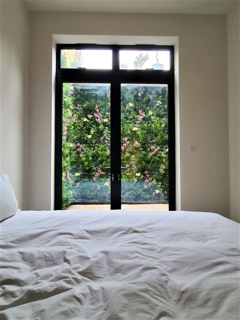 A View from the bedroom of a Tooting property, showing a faux green wall outside