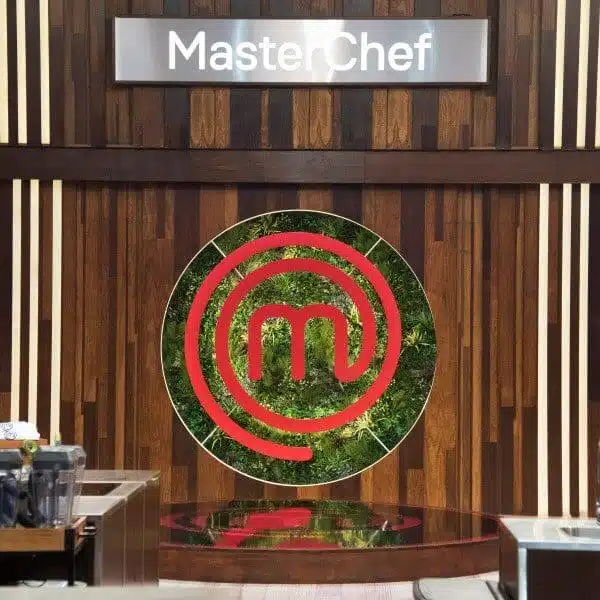 The PROJECT SPOTLIGHT: MasterChef TV Set in Portugal showcases a kitchen with a prominent MasterChef sign. A circular design with a red 