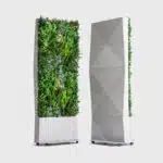 The Modular Green Wall Partitions include two vertical units: one with lush plants and the other featuring a geometric fabric cover. Both stand on gray wheeled bases against a plain white backdrop.