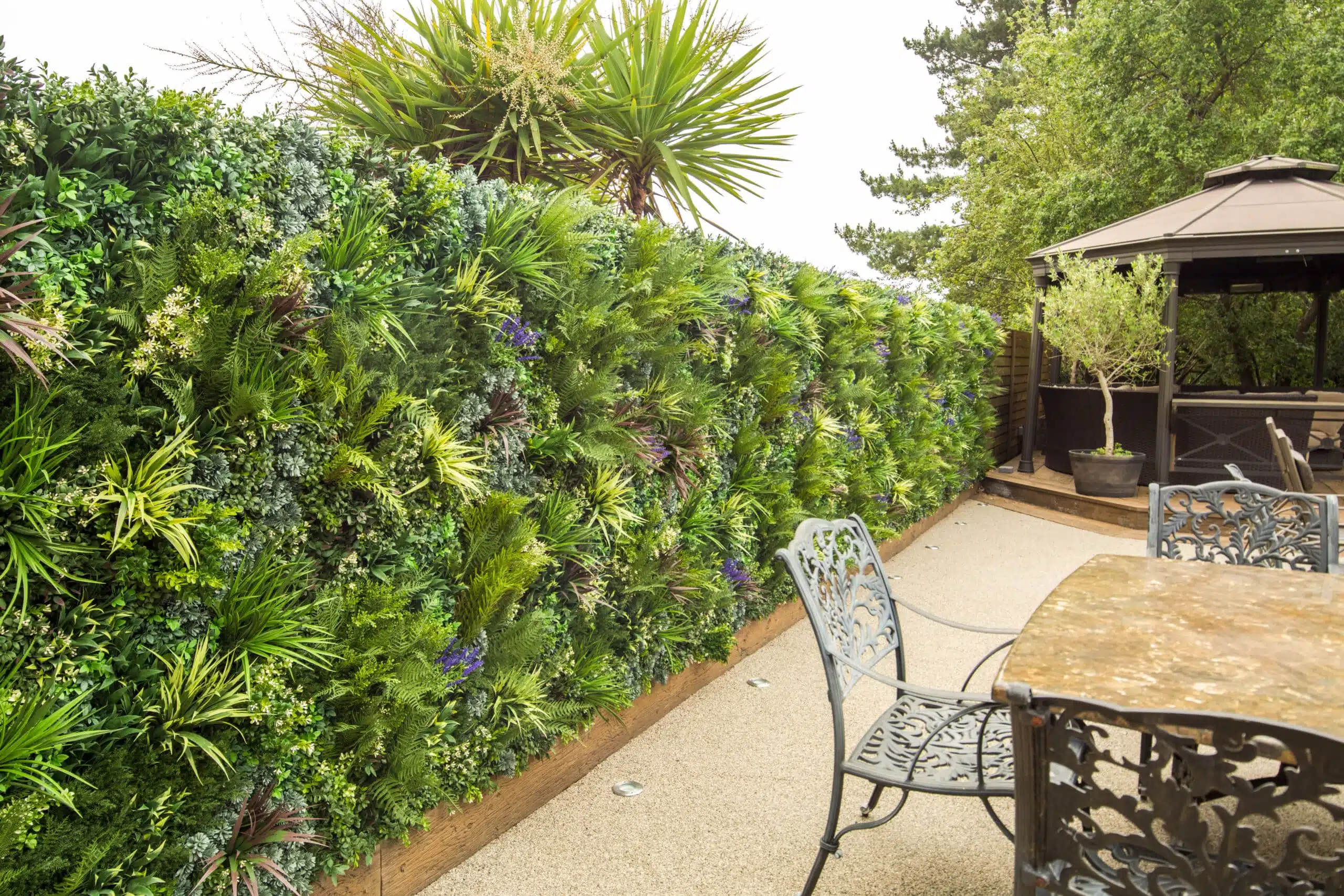 an artificial green wall installation on a fence in a garden
