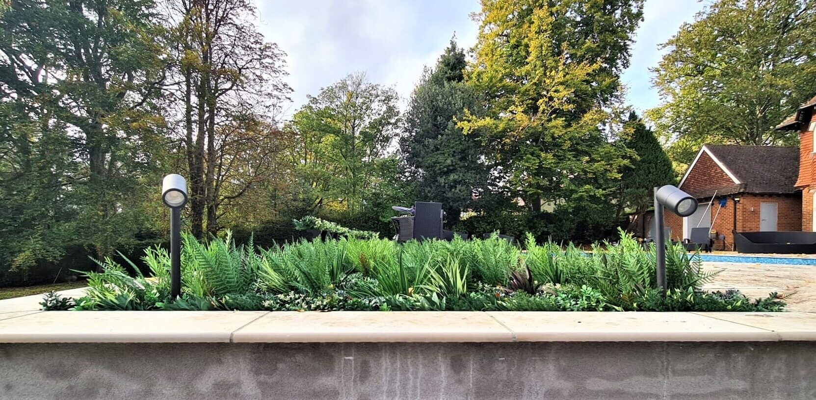 A garden project that has been improved by adding high quality fake plants for outside
