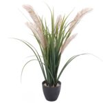 A realistic green artifiicial grass plant in a black pot